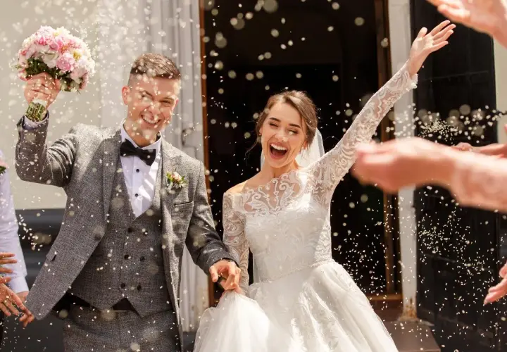 Novios felices, rodeados de confeti, celebrando su boda. ¡Un sueño hecho realidad!